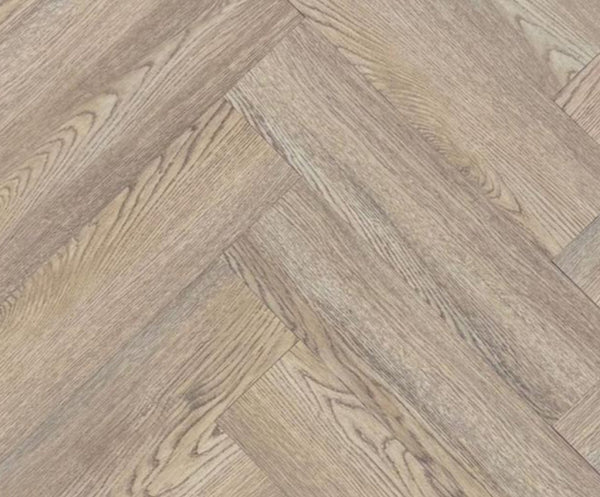 Close-up texture detail of light brown herringbone luxury vinyl tiles