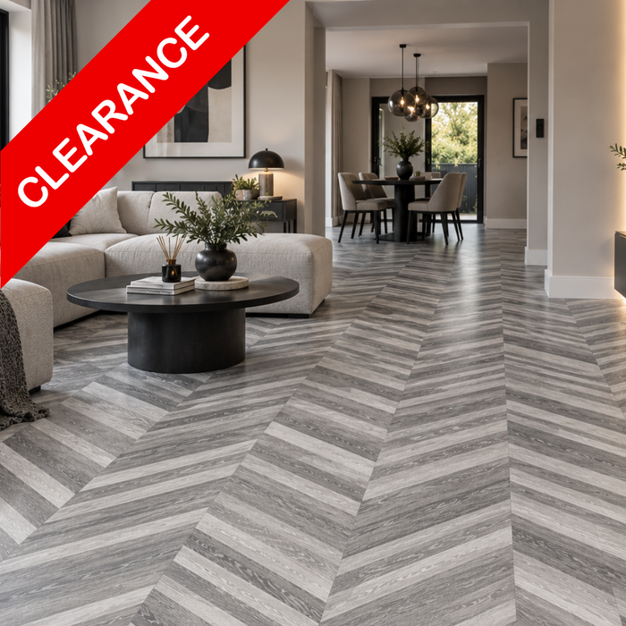 Gray and white wood-look flooring installed in a modern living room and dining area, with a red diagonal 'CLEARANCE' banner overlay in the top left corner.