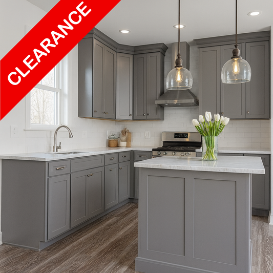 A modern kitchen interior with gray cabinets, a white island countertop, wood-look flooring, pendant lights, and a red diagonal banner reading CLEARANCE.