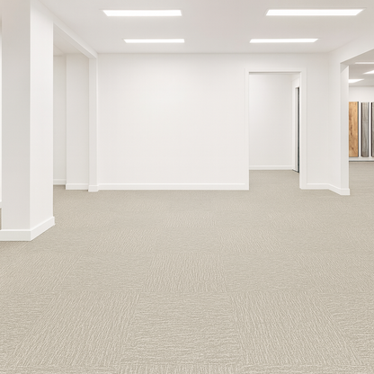 Empty office space with light gray LVT Carpet like flooring and white walls. 